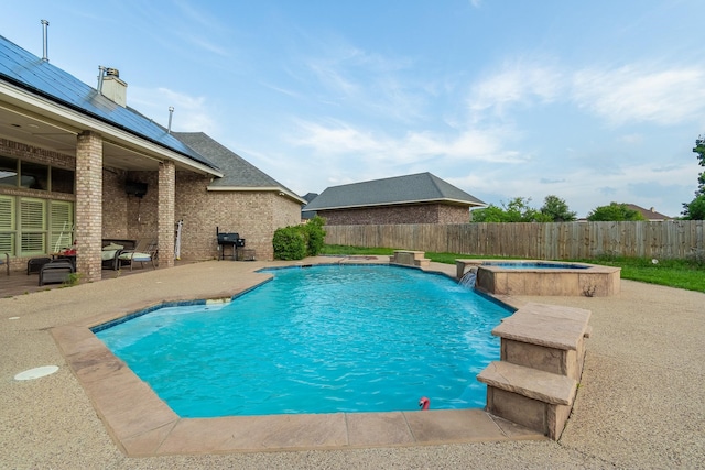 view of swimming pool featuring a patio area, an in ground hot tub, and pool water feature