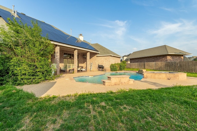 view of swimming pool featuring an in ground hot tub, a patio, and a yard