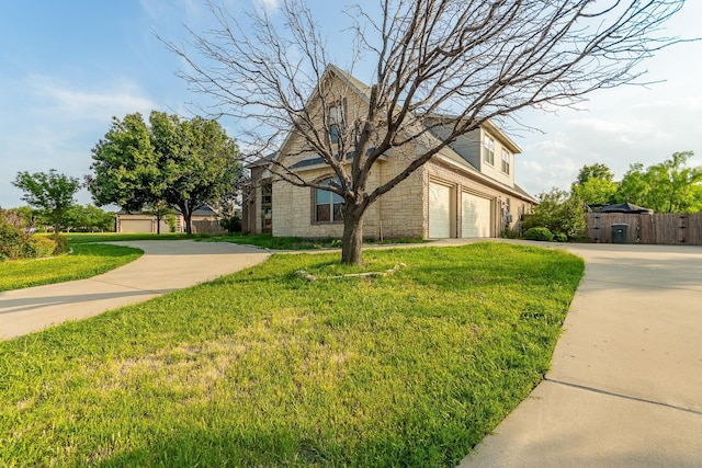 view of front of home with a garage and a front lawn