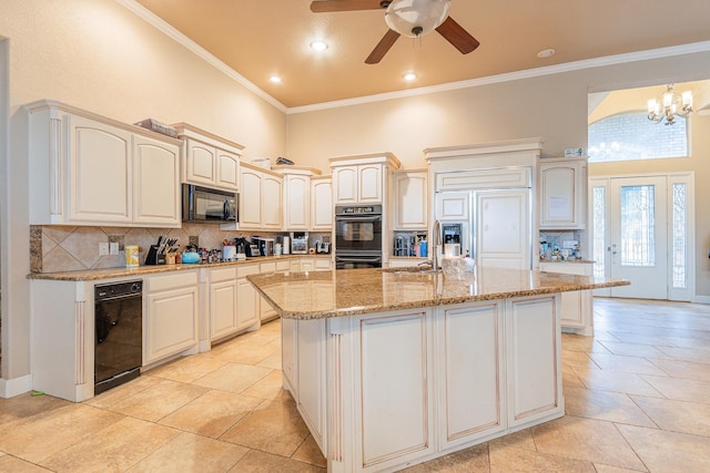 kitchen featuring tasteful backsplash, black appliances, crown molding, ceiling fan with notable chandelier, and an island with sink