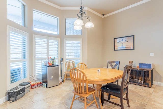 tiled dining room featuring crown molding, a chandelier, and a high ceiling