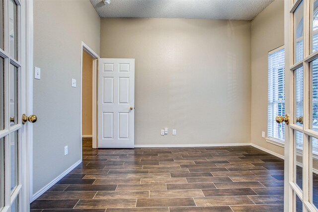 spare room featuring french doors and a textured ceiling