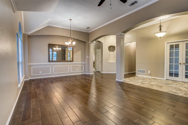 interior space featuring ornate columns, hardwood / wood-style flooring, ornamental molding, ceiling fan, and french doors