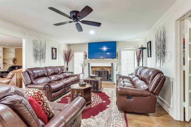 living room with light wood-type flooring and ceiling fan