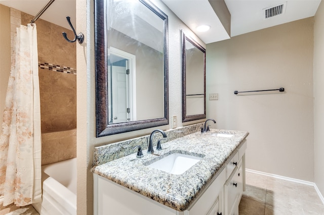 bathroom featuring shower / bath combo, dual bowl vanity, and tile patterned flooring