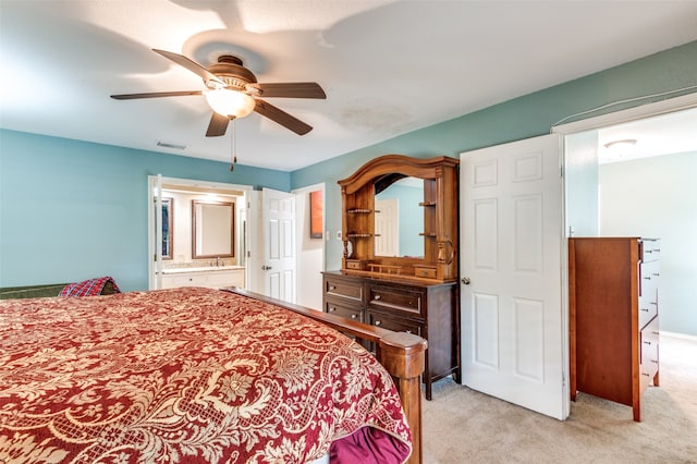 carpeted bedroom featuring ceiling fan and connected bathroom