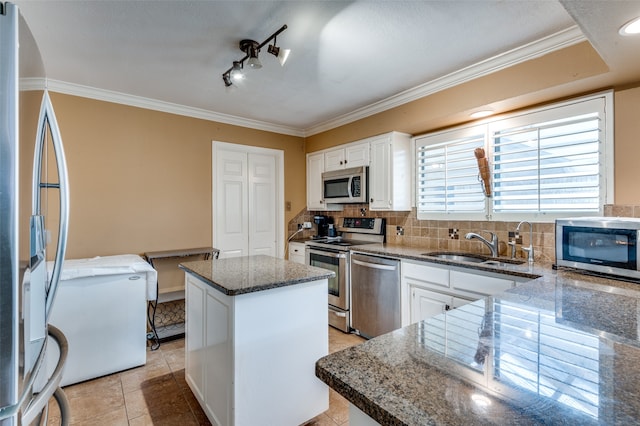 kitchen with a center island, appliances with stainless steel finishes, tasteful backsplash, and white cabinetry