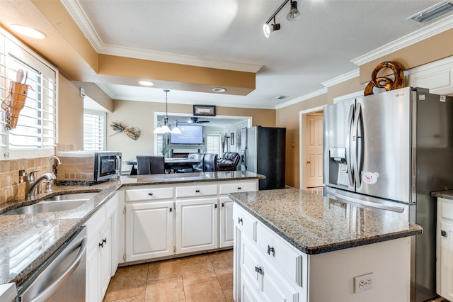 kitchen featuring white cabinets, sink, appliances with stainless steel finishes, light tile patterned floors, and track lighting