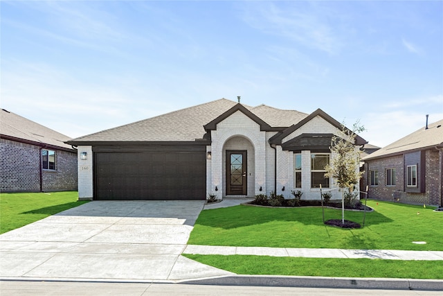 view of front of property featuring a garage and a front yard