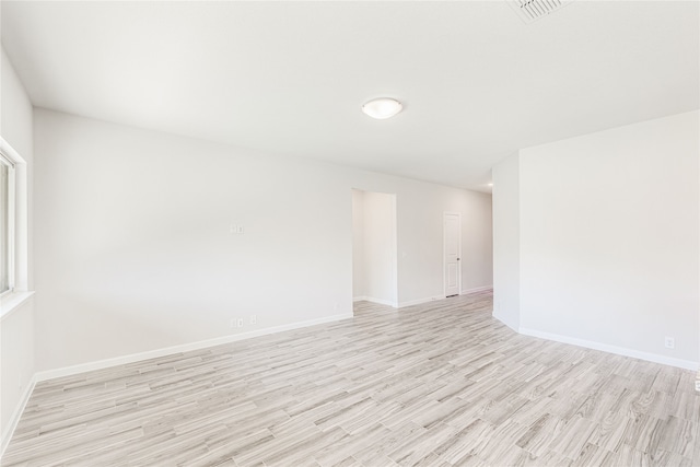 spare room featuring light hardwood / wood-style flooring