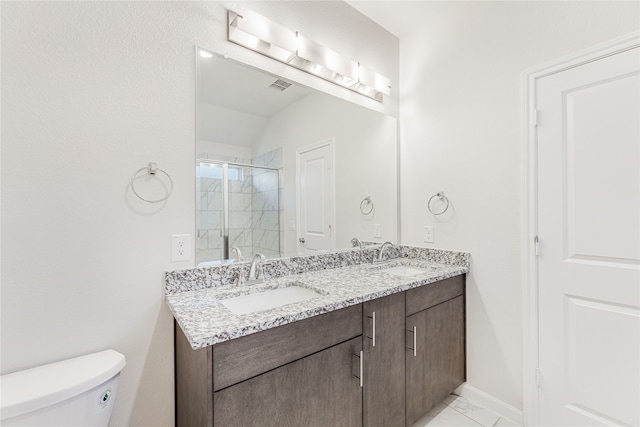 bathroom with an enclosed shower, vanity, and toilet