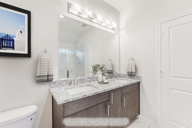 bathroom with vanity, toilet, and an enclosed shower