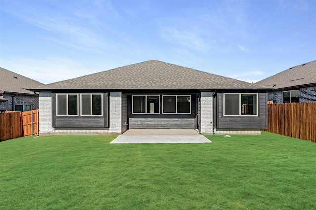 back of house featuring a yard and a patio area