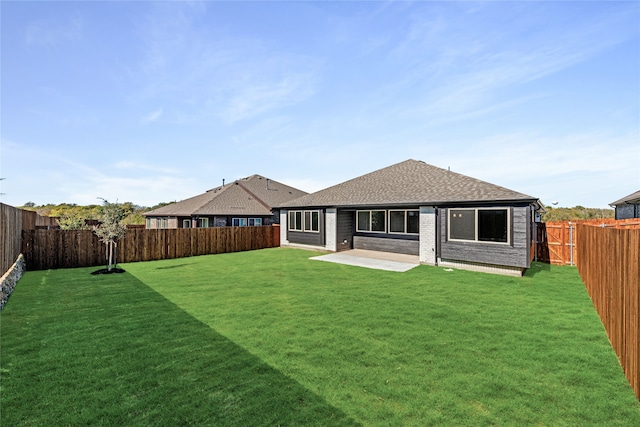 rear view of property with a patio area and a lawn