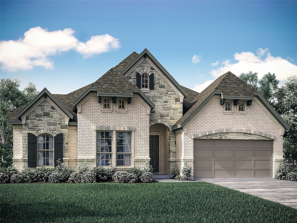 french provincial home featuring a garage and a front yard