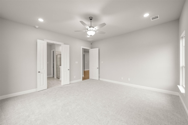 unfurnished bedroom featuring light carpet and ceiling fan