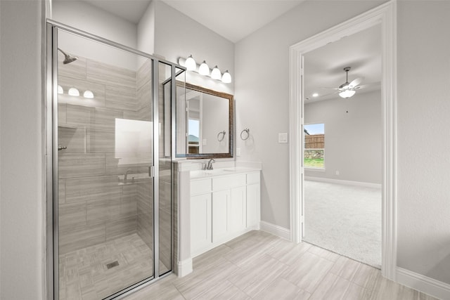 bathroom featuring ceiling fan, vanity, and a shower with shower door