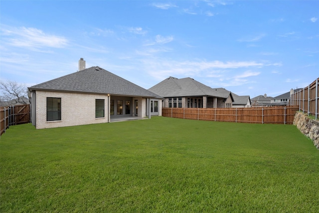 rear view of house with a lawn