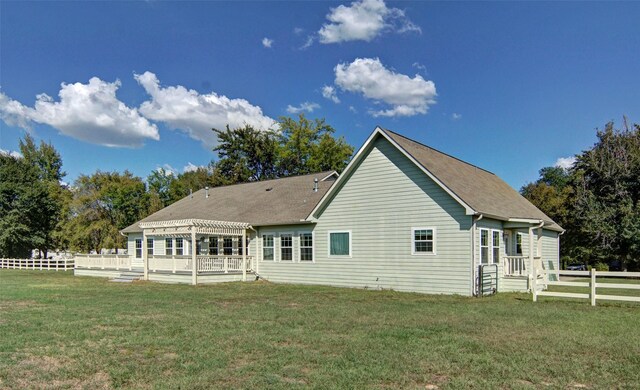 rear view of house featuring a yard