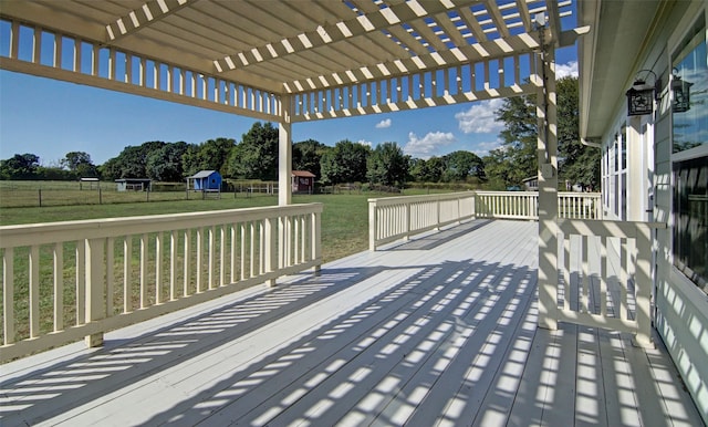 deck with a pergola, a yard, and a storage shed