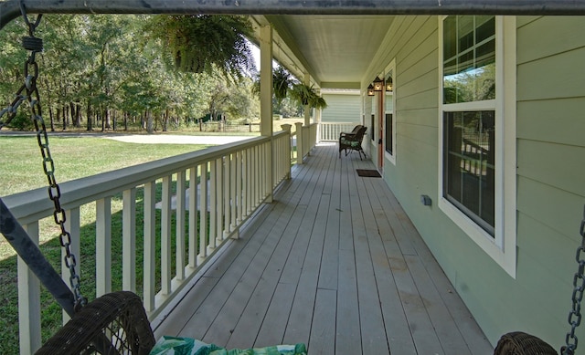 wooden terrace with a lawn