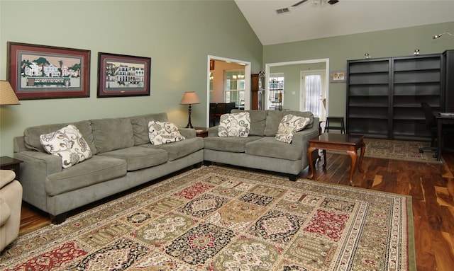 living room featuring wood-type flooring and high vaulted ceiling