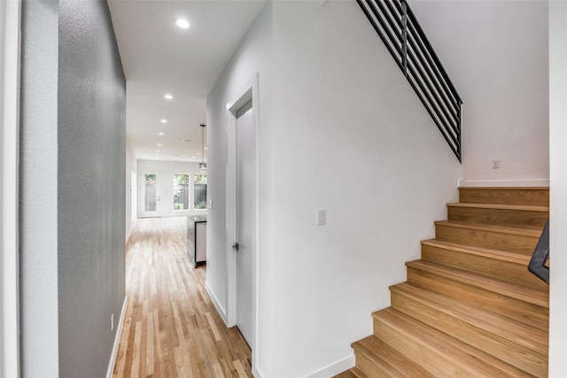 stairs with hardwood / wood-style flooring