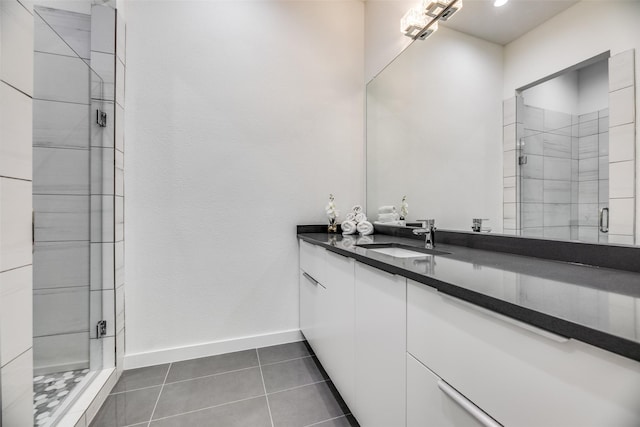 bathroom featuring tile patterned floors, an enclosed shower, and vanity