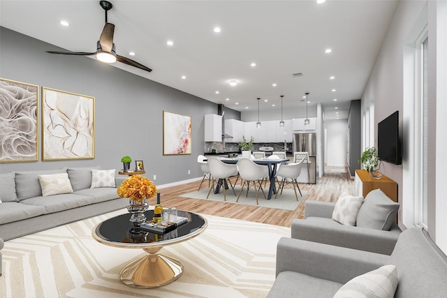 living room with ceiling fan and light hardwood / wood-style floors