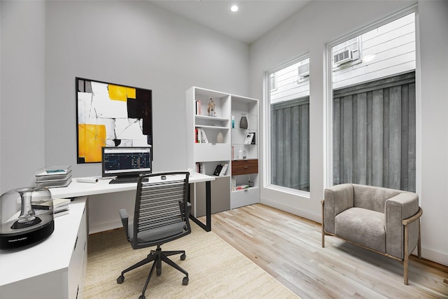 home office with light hardwood / wood-style floors