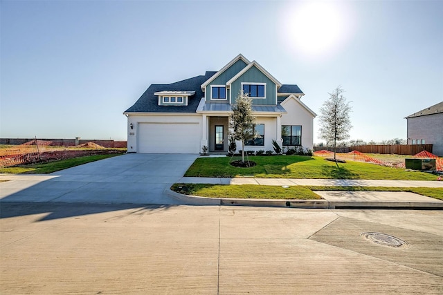 view of front of property with a front yard and a garage