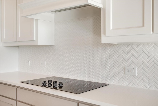 3834 Foot Hls, Midlothian, TX 76065 - kitchen featuring decorative backsplash, light countertops, black electric cooktop, and white cabinets
