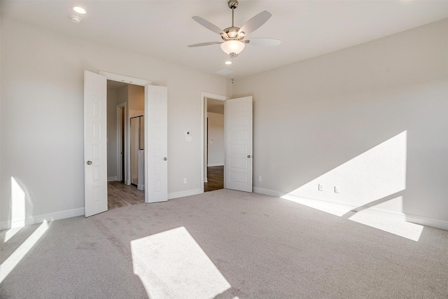 unfurnished bedroom with light carpet and ceiling fan