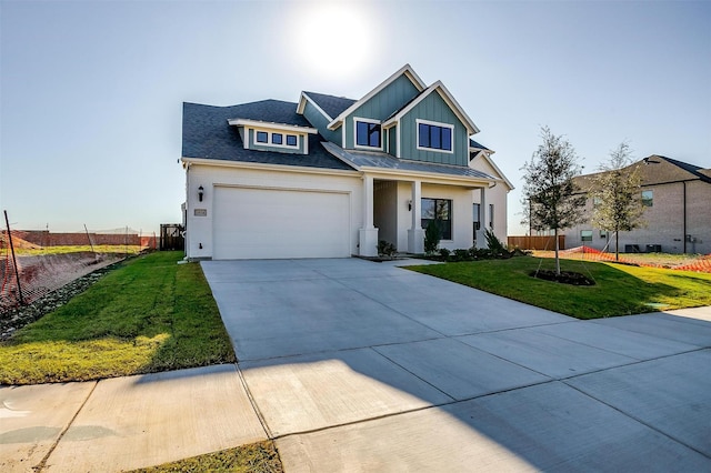 view of front of home with cooling unit, a garage, and a front yard