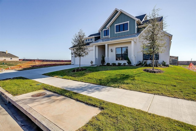 view of front of house featuring a front lawn and a garage