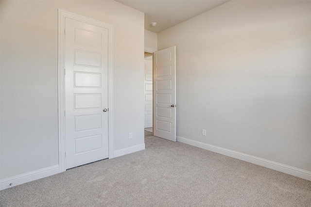 unfurnished bedroom with light colored carpet