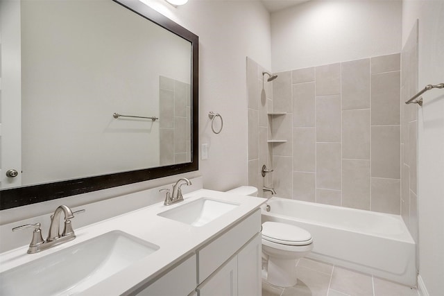 full bathroom featuring tile patterned flooring, vanity, tiled shower / bath combo, and toilet