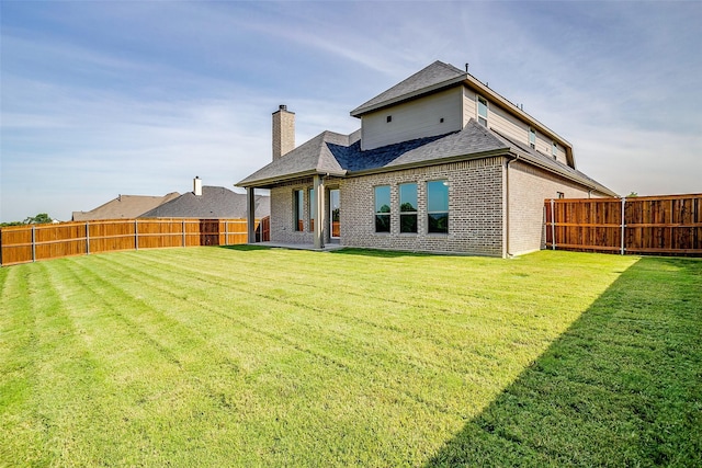 3834 Foot Hls, Midlothian, TX 76065 - rear view of property with a lawn, a shingled roof, a fenced backyard, and brick siding