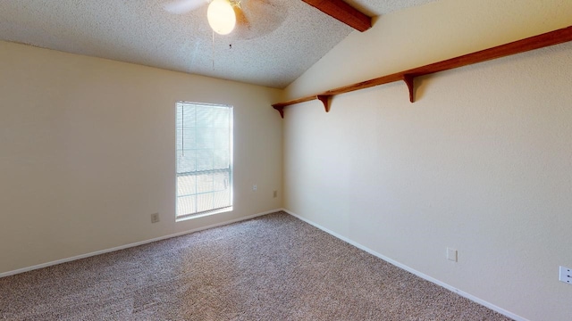 empty room featuring carpet, a textured ceiling, vaulted ceiling with beams, and ceiling fan