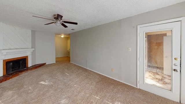 unfurnished living room featuring a fireplace, a textured ceiling, carpet, and ceiling fan