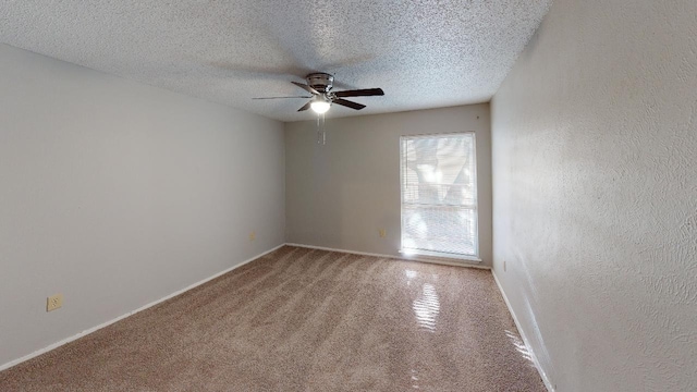 spare room with ceiling fan, carpet flooring, and a textured ceiling