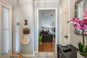 corridor with crown molding and light tile patterned floors