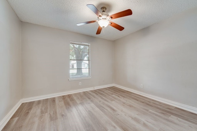 empty room featuring ceiling fan, a textured ceiling, and light hardwood / wood-style floors