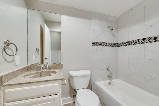 full bathroom featuring tiled shower / bath combo, vanity, and toilet