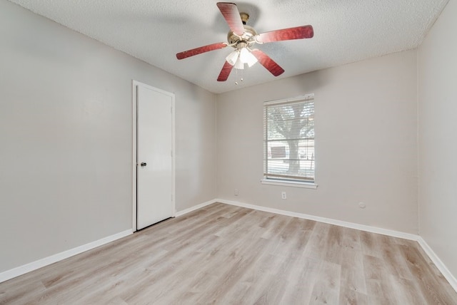 unfurnished room featuring ceiling fan, light hardwood / wood-style floors, and a textured ceiling