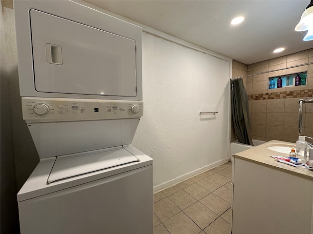 washroom with stacked washer and clothes dryer and light tile patterned floors