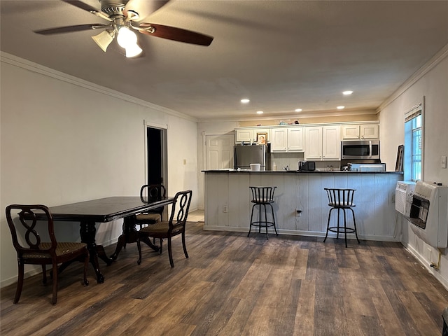 kitchen featuring ceiling fan, white cabinets, dark hardwood / wood-style floors, appliances with stainless steel finishes, and kitchen peninsula