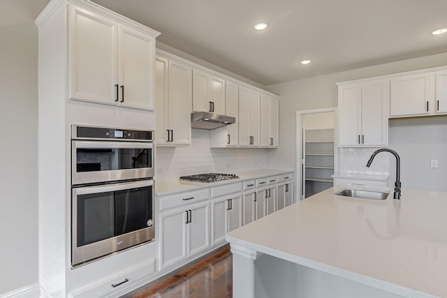 kitchen with white cabinetry, sink, backsplash, and appliances with stainless steel finishes