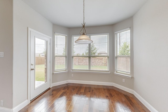 unfurnished dining area featuring wood-type flooring