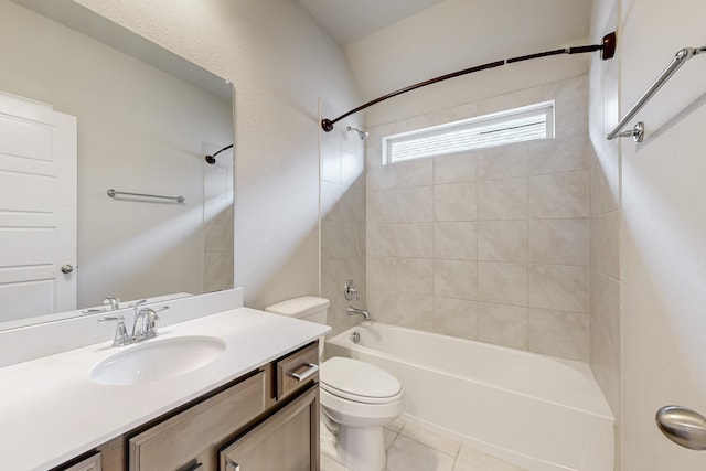 full bathroom featuring tiled shower / bath, tile patterned floors, toilet, and vanity